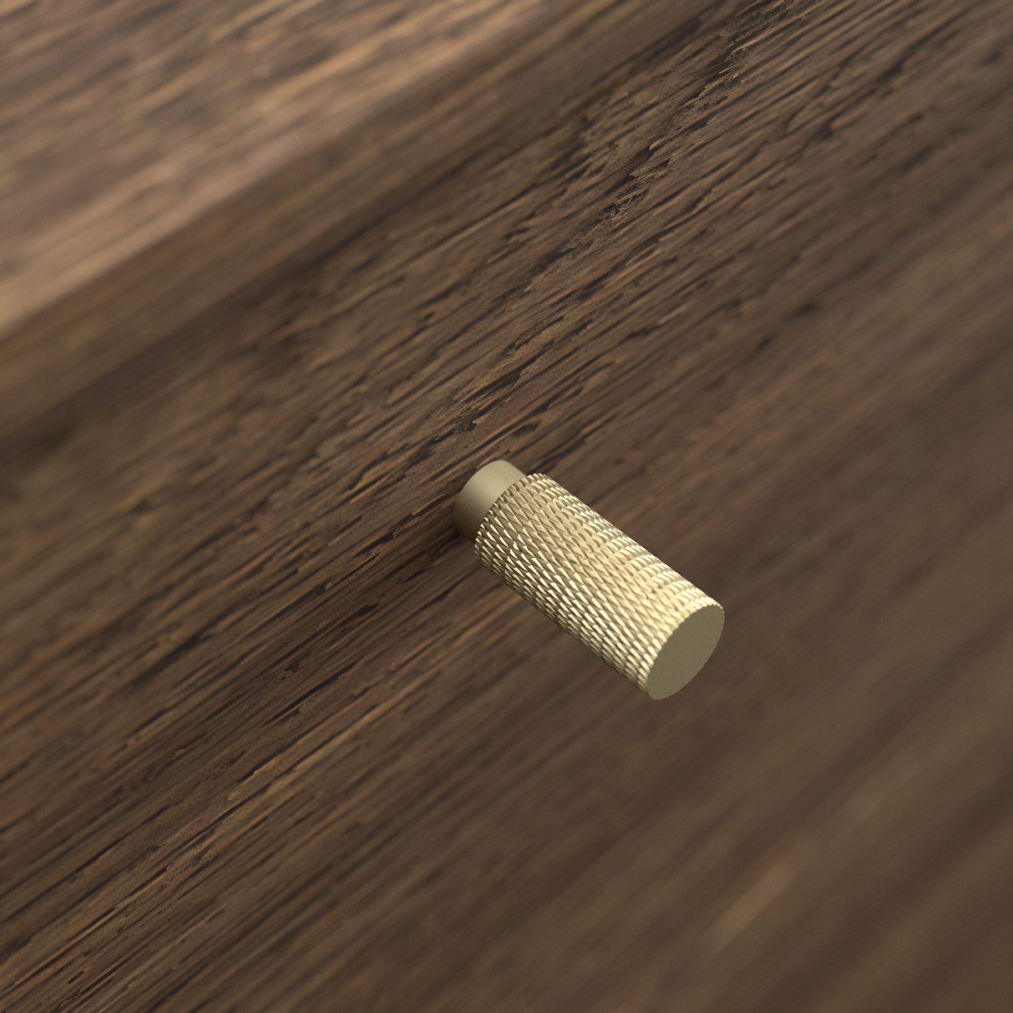 Close-up product photography of a knurled brass-tone handle on a walnut drawer front